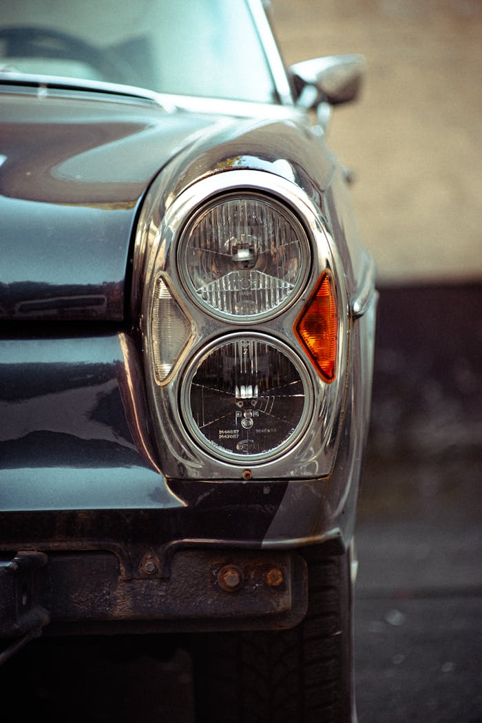 About Close-up of an antique car's headlight, showcasing classic design and chrome finish.